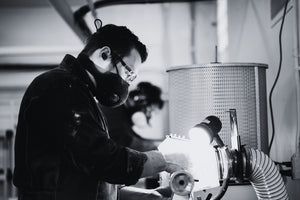 Black and white photo of two men turning and finishing Daggerfish hand line fishing reels