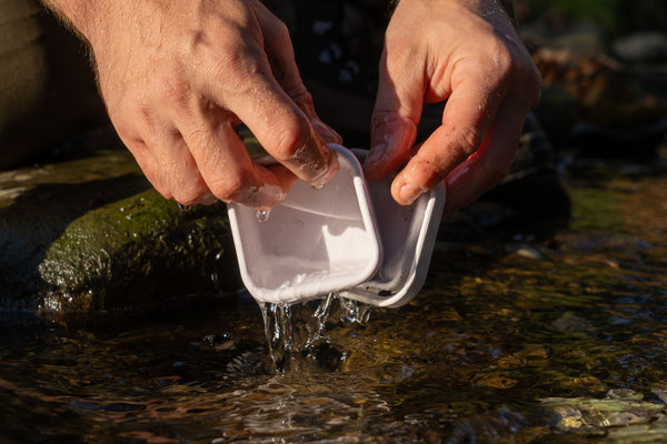 Cleaning a Daggerfish Belt Box in a stream 