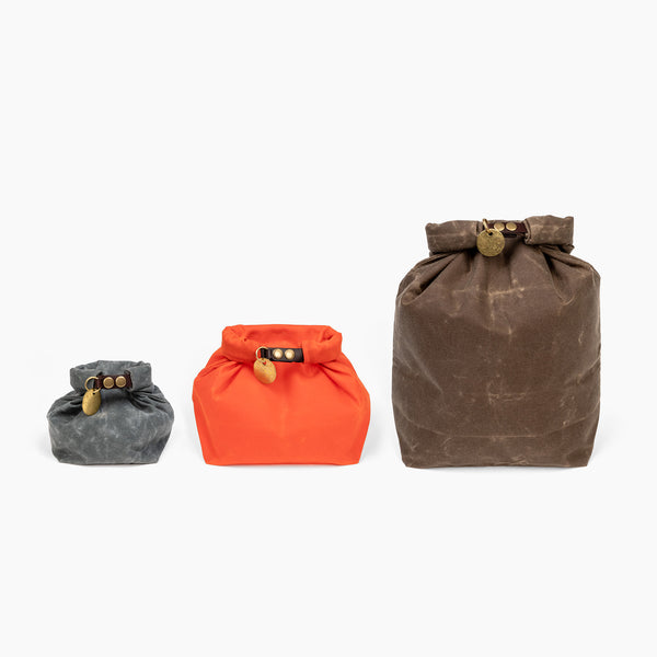 Three sized of waxed canvas roll top stuff sacks compared