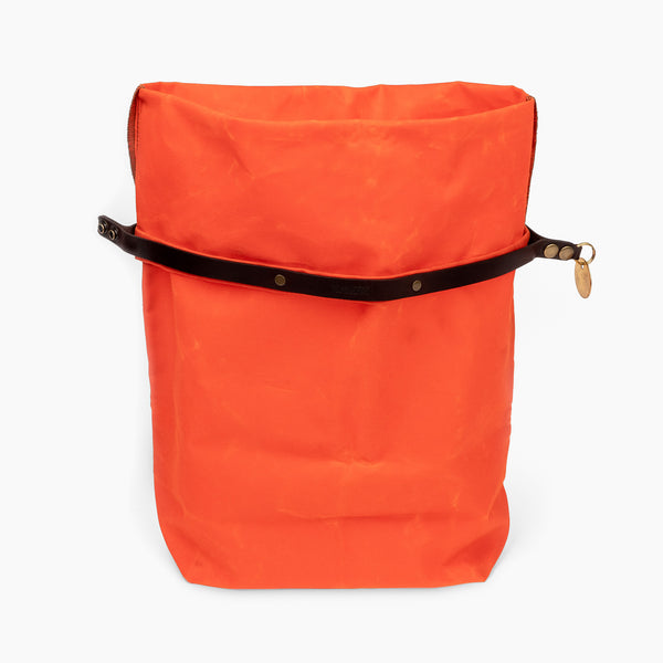 Open large hunter orange waxed canvas roll top stuff sack with leather closure and brass tag 