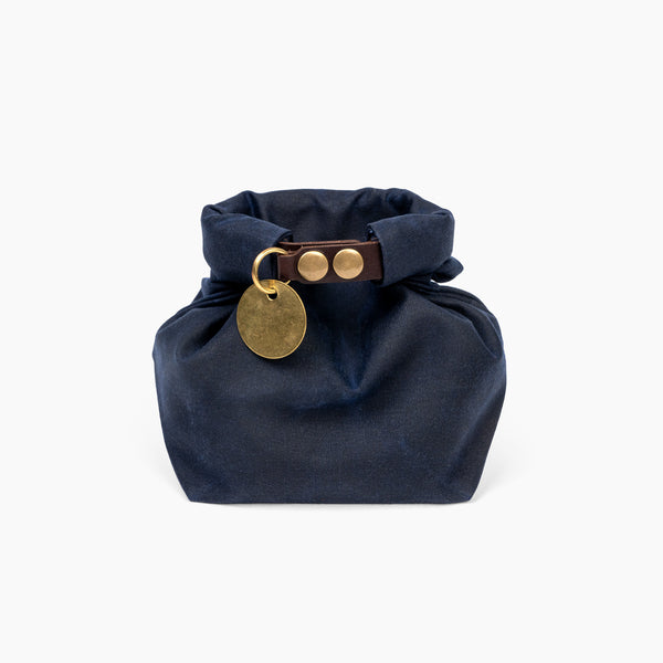 Closed Small Navy Blue waxed canvas roll top stuff sack with leather closure and brass tag 