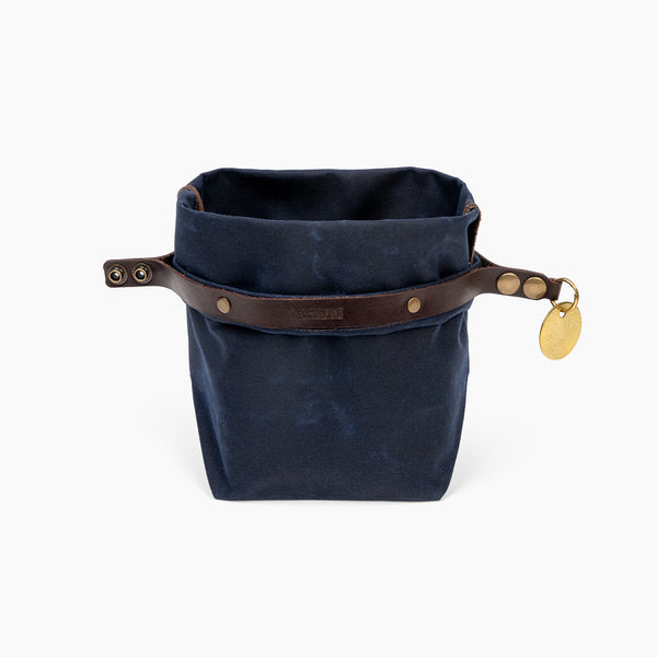 Open Small Navy Blue waxed canvas roll top stuff sack with leather closure and brass tag 