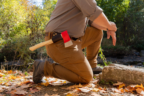 Kneeling with an axe in the Daggerfish Snap Sling