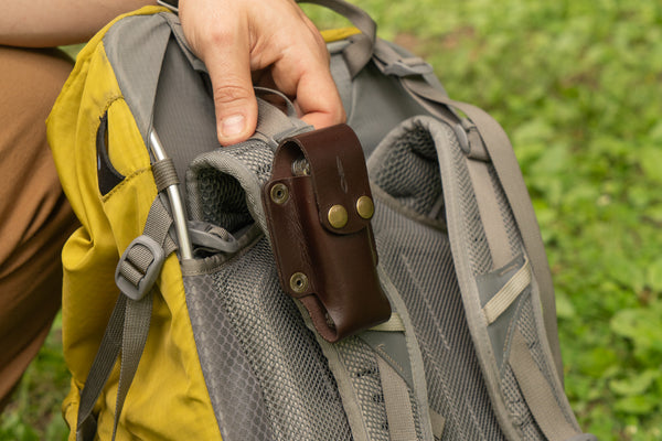 Using the Universal Knife Sheath as a vertical knife sheath snapped onto a backpack strap