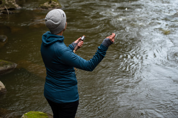 Woman casting a Daggerfish handline in a stream